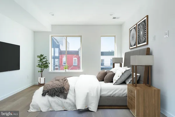 a bedroom with a bed and a flat screen television