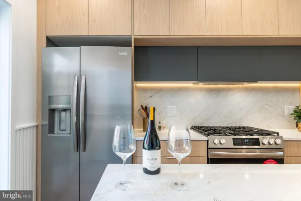 a kitchen with a stove and a refrigerator