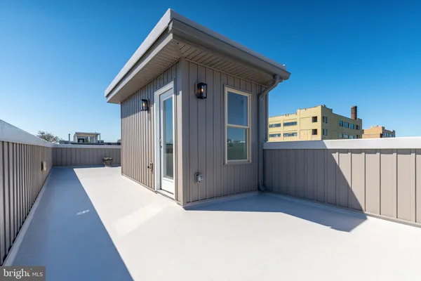 a view of a house with a wooden deck