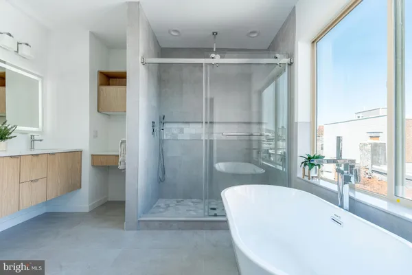 a bathroom with a bathtub and a shower