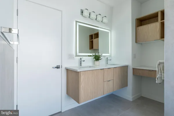 a bathroom with a sink vanity and mirror