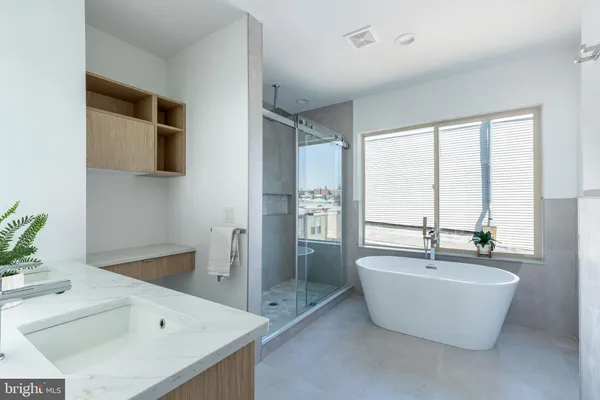 a bathroom with a bathtub and a sink