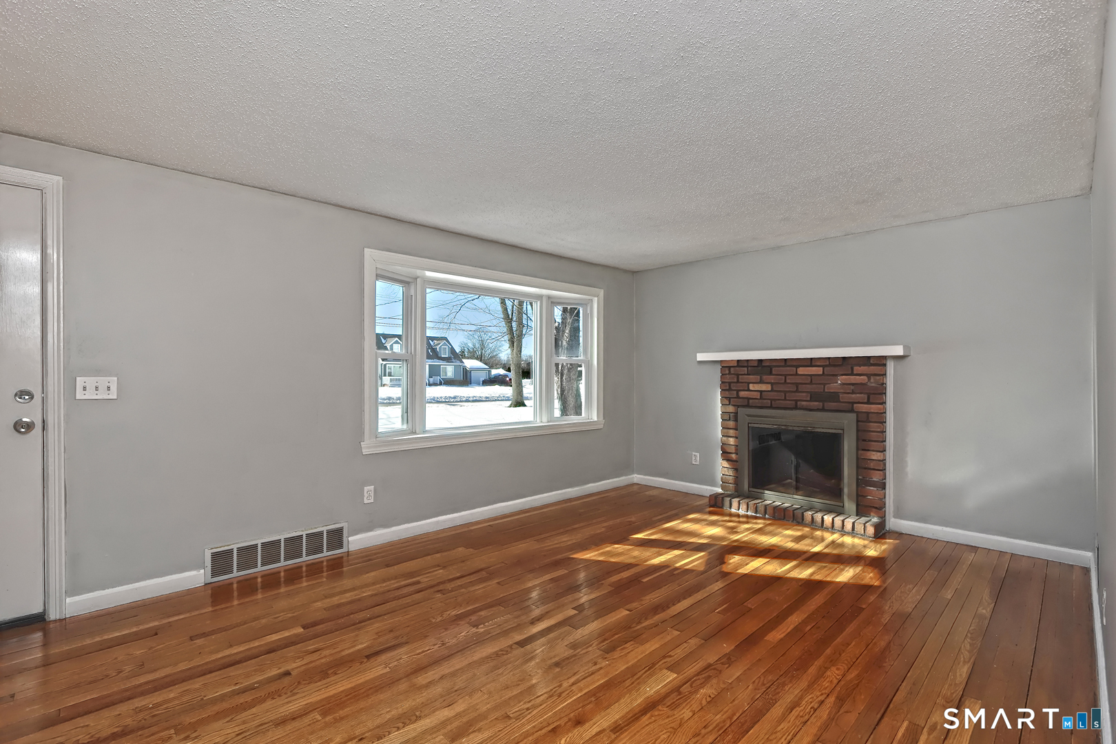 10 Hemingway Road North Haven, CT 06473 - Photo 11 of 38 Plenty of natural light through large bow window. Wood fireplace.