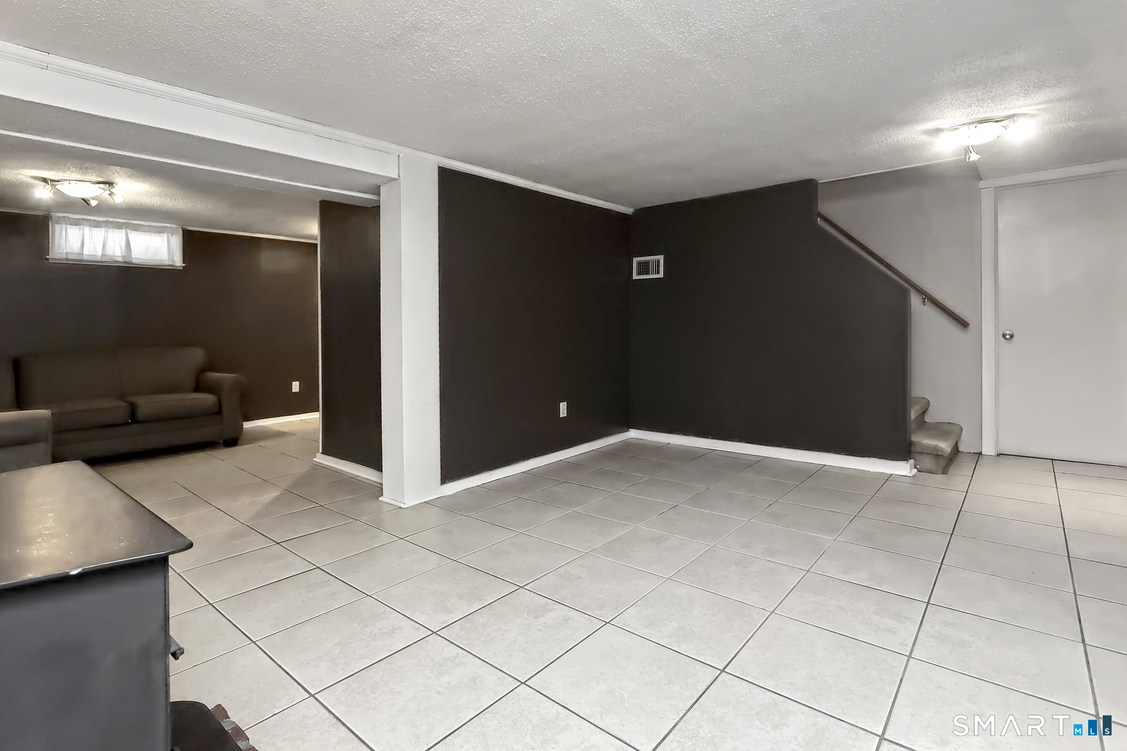 10 Hemingway Road North Haven, CT 06473 - Photo 30 of 38 lower level family room with tile floor and wood stove