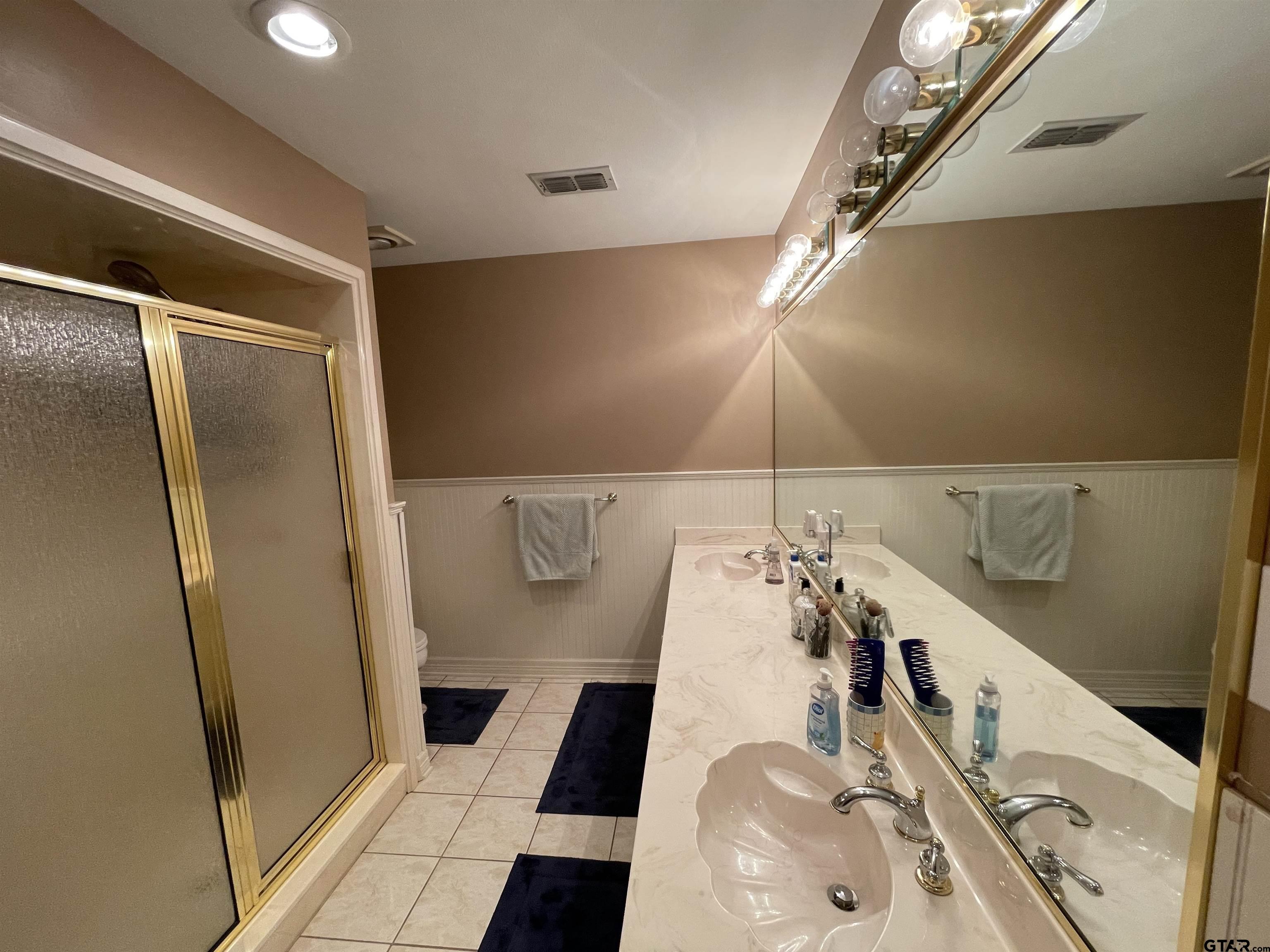 3617 Flagstone Drive Tyler, TX 75707 - Photo 14 of 45 a bathroom with a sink and mirror