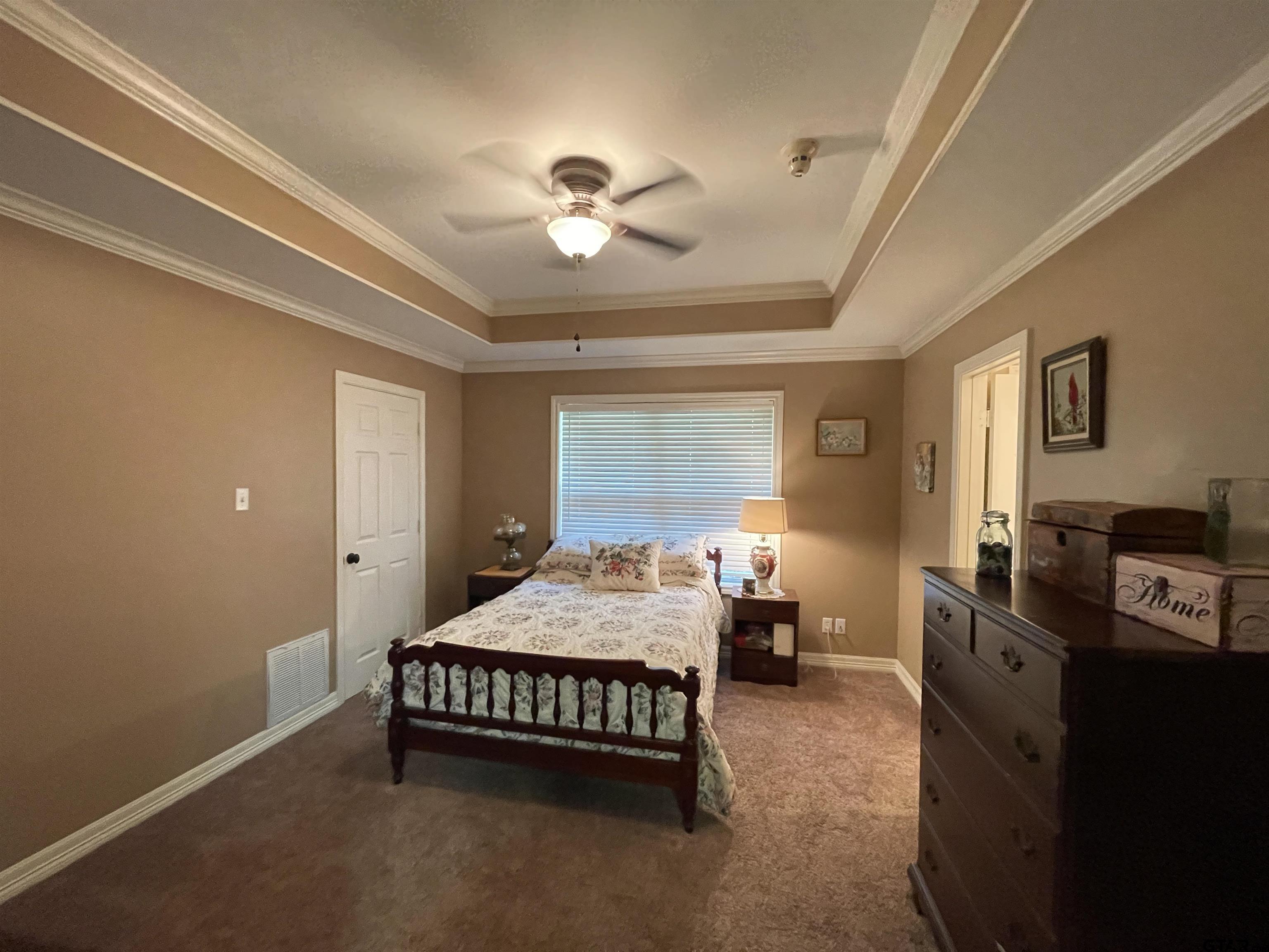3617 Flagstone Drive Tyler, TX 75707 - Photo 15 of 45 a bedroom with a bed and a chandelier