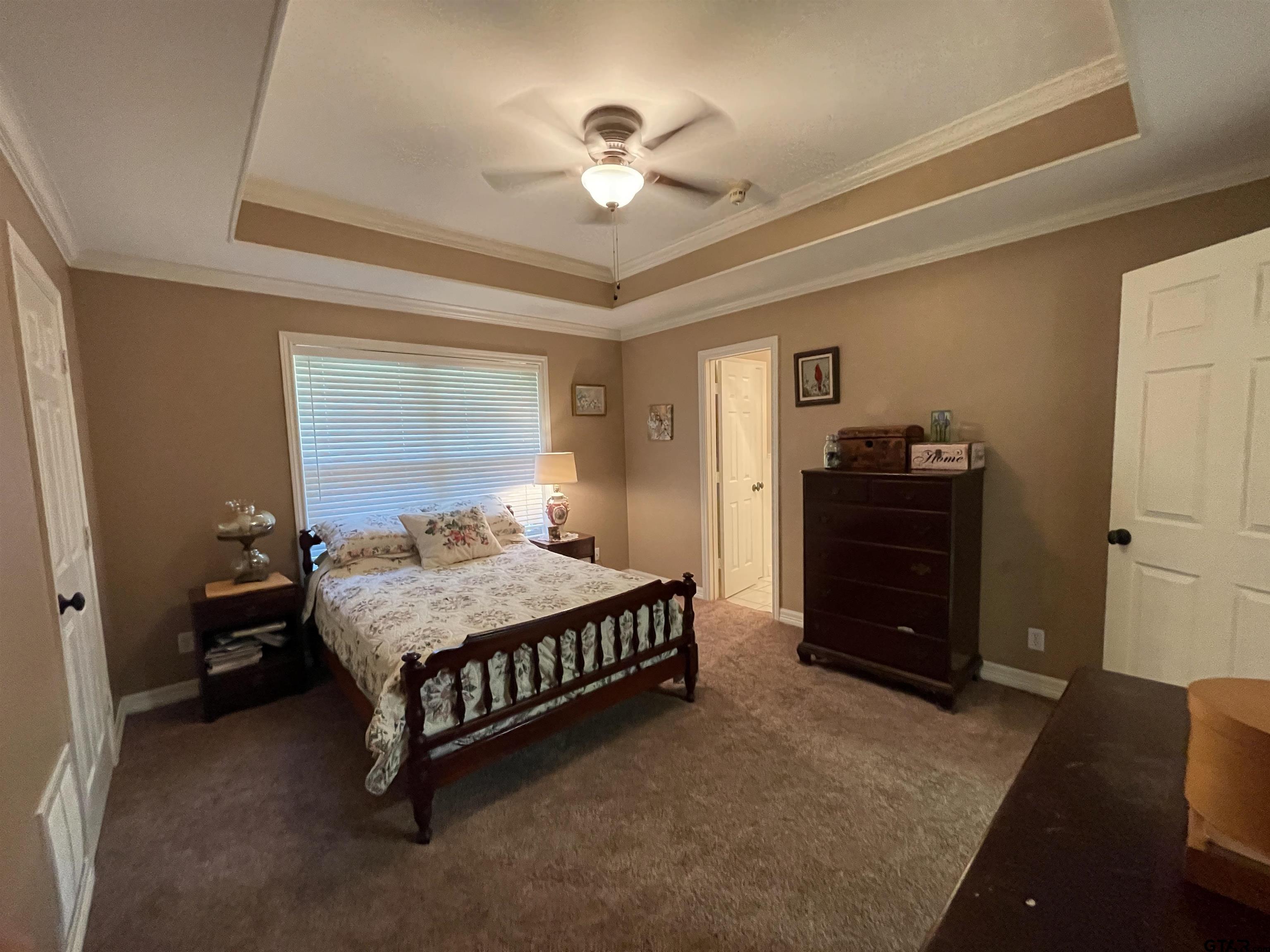 3617 Flagstone Drive Tyler, TX 75707 - Photo 16 of 45 a bedroom with a bed and a chandelier