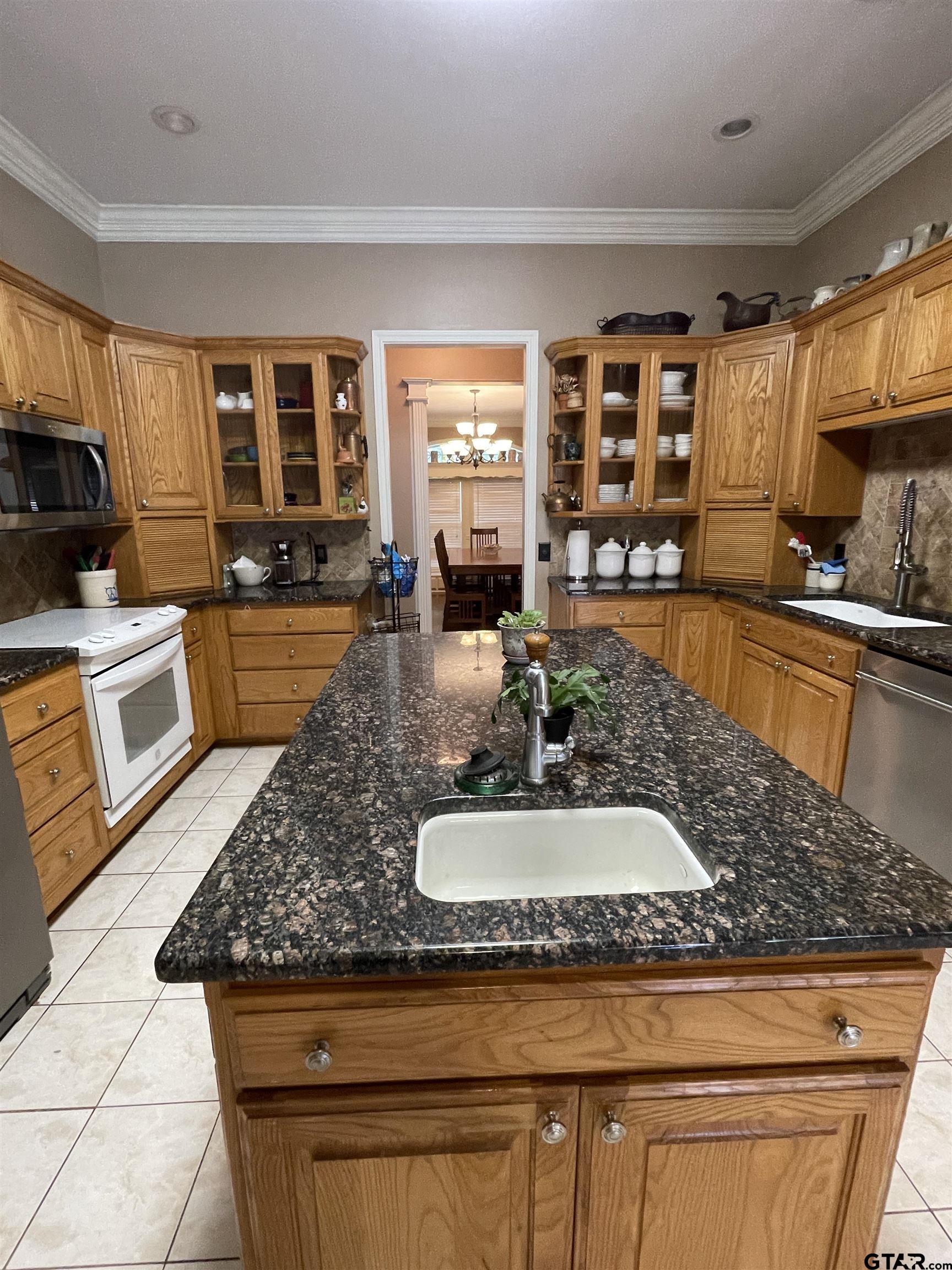 3617 Flagstone Drive Tyler, TX 75707 - Photo 19 of 45 a kitchen with stainless steel appliances granite countertop a sink and a stove