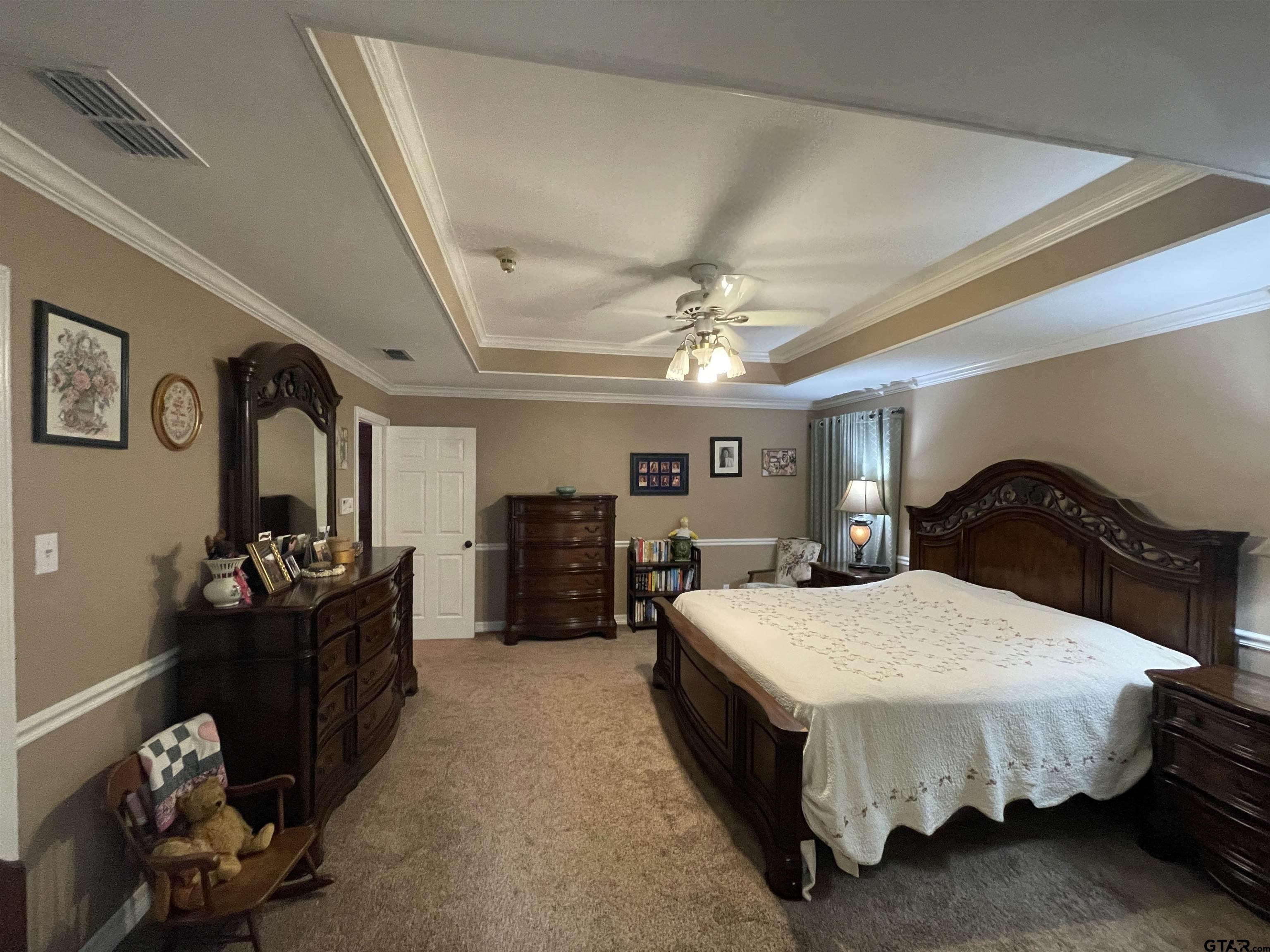 3617 Flagstone Drive Tyler, TX 75707 - Photo 35 of 45 a spacious bedroom with a bed and ceiling fan