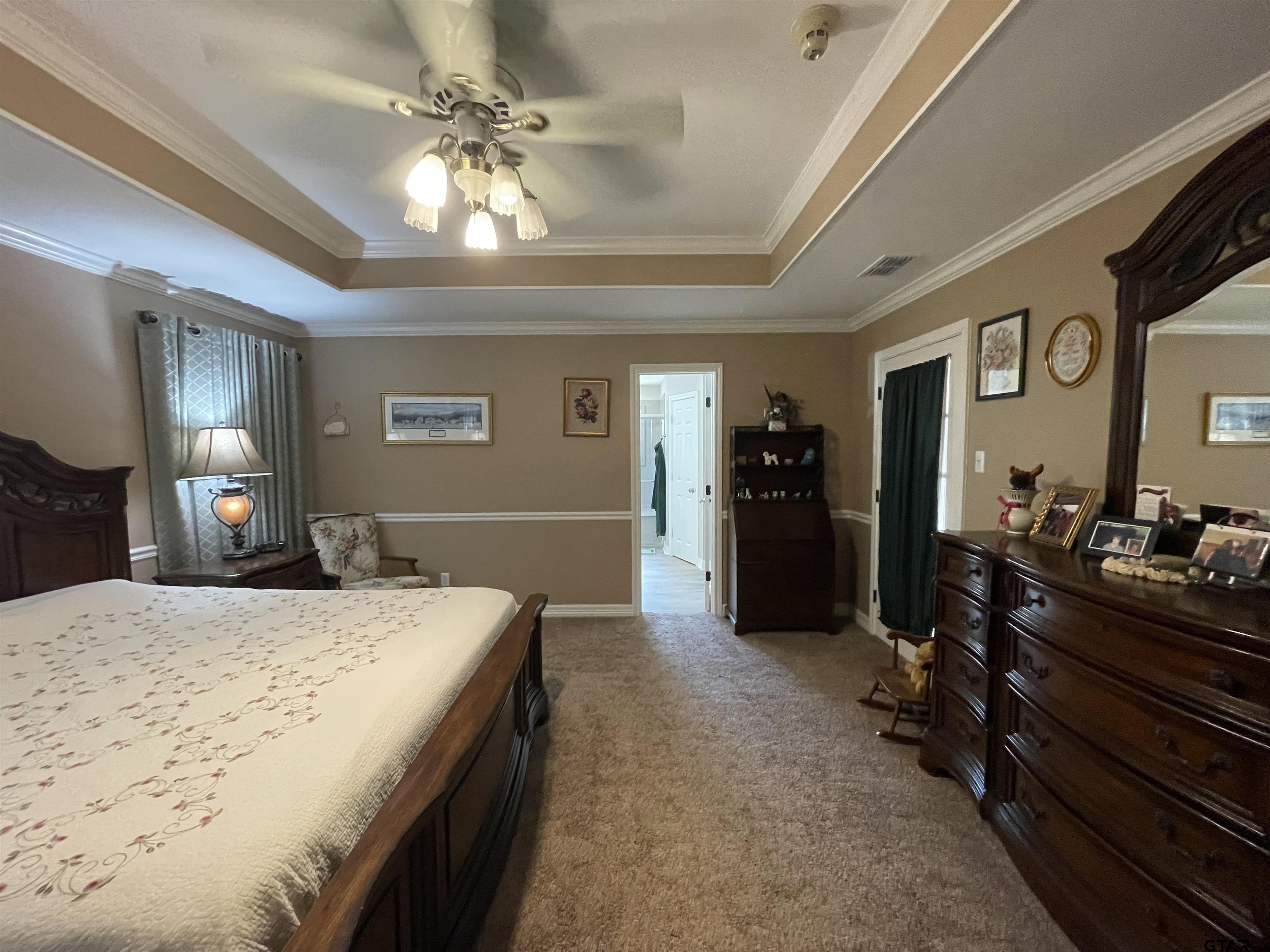 3617 Flagstone Drive Tyler, TX 75707 - Photo 37 of 45 a bedroom with a bed and a chandelier