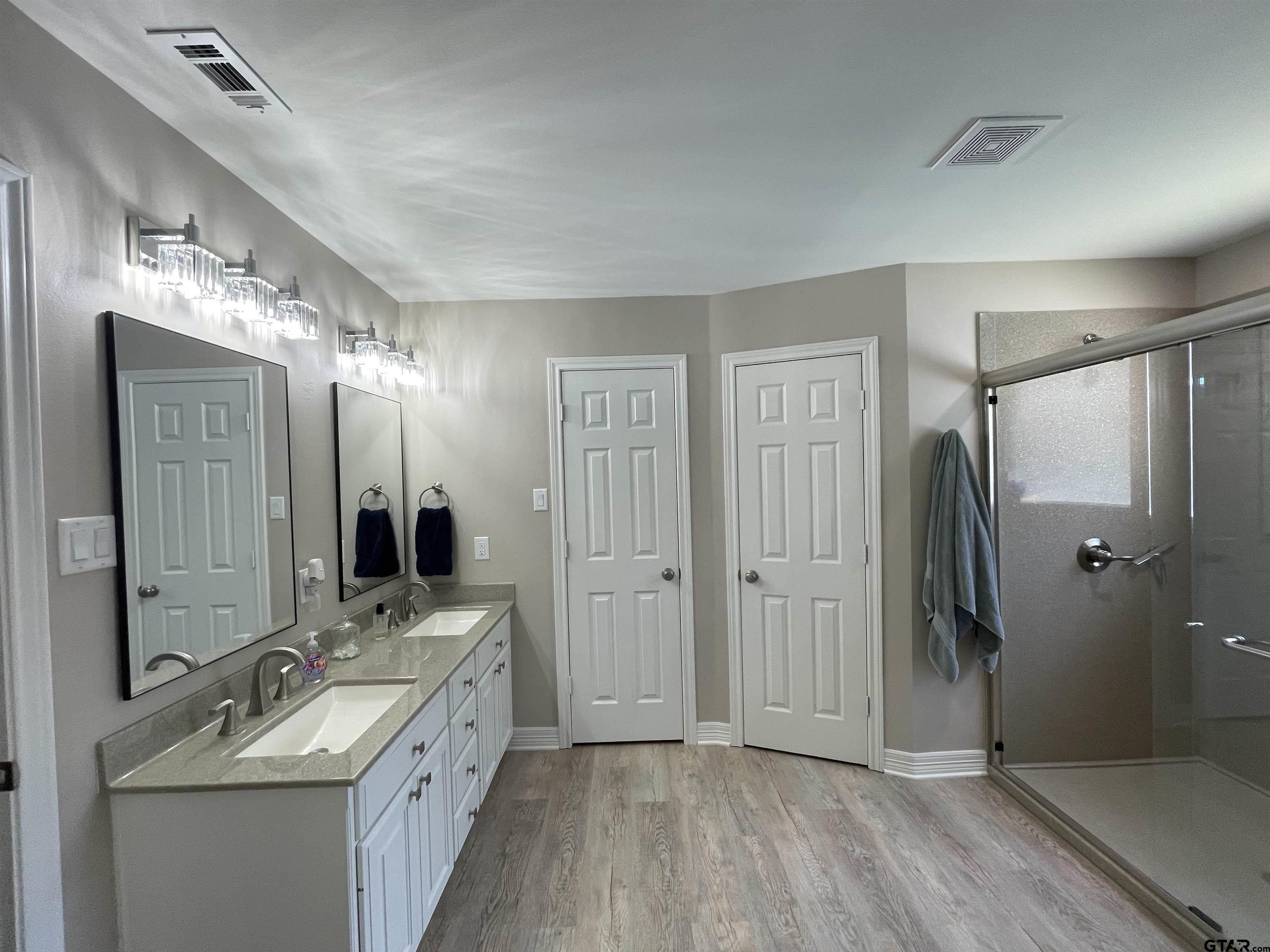 3617 Flagstone Drive Tyler, TX 75707 - Photo 39 of 45 a bathroom with a double vanity sink mirror and shower