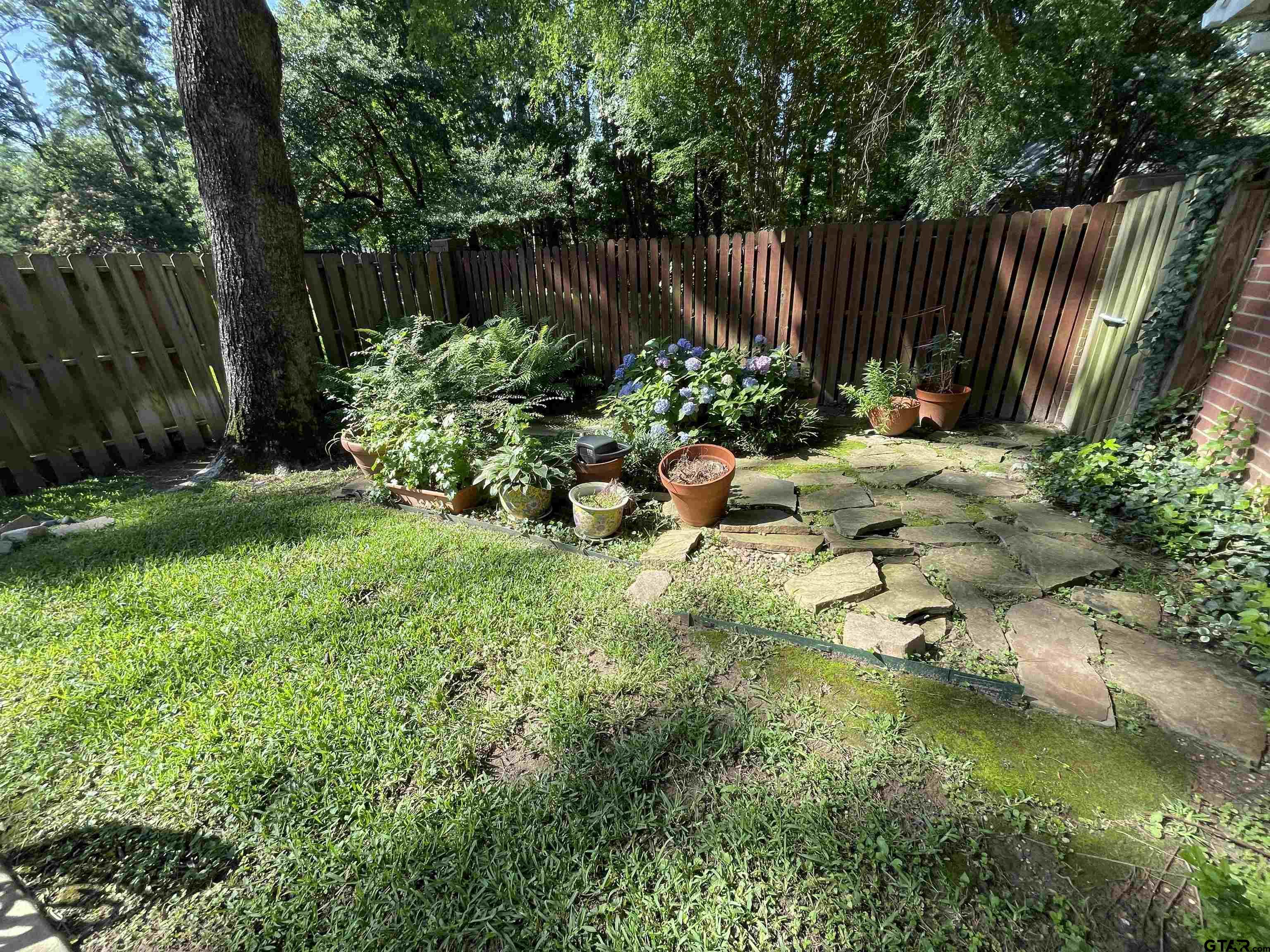 3617 Flagstone Drive Tyler, TX 75707 - Photo 45 of 45 a backyard of a house with lots of green space
