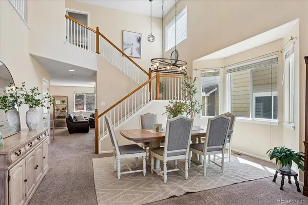 a dining room with furniture entryway and wooden floor