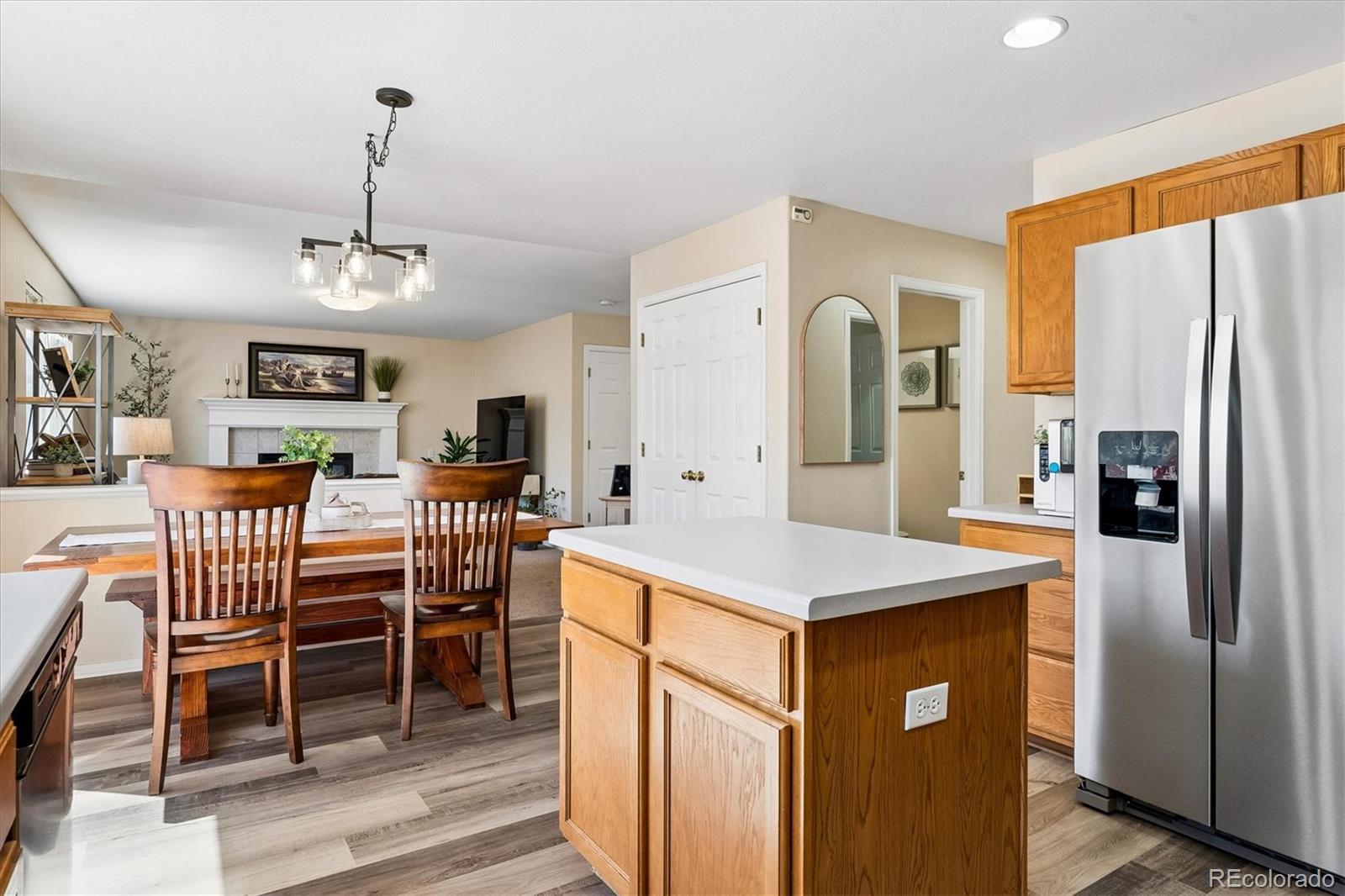 10534 Westcliff Place Highlands Ranch, CO 80130 - Photo 16 of 38 a view of a kitchen with a dining table and chairs