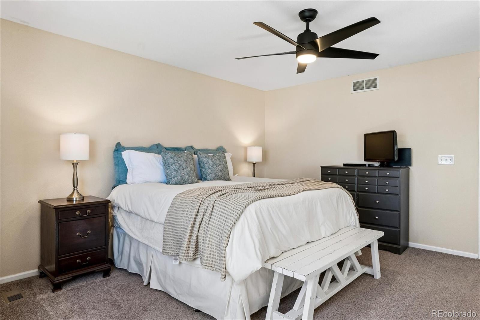 10534 Westcliff Place Highlands Ranch, CO 80130 - Photo 17 of 38 a bedroom with a bed and a tv
