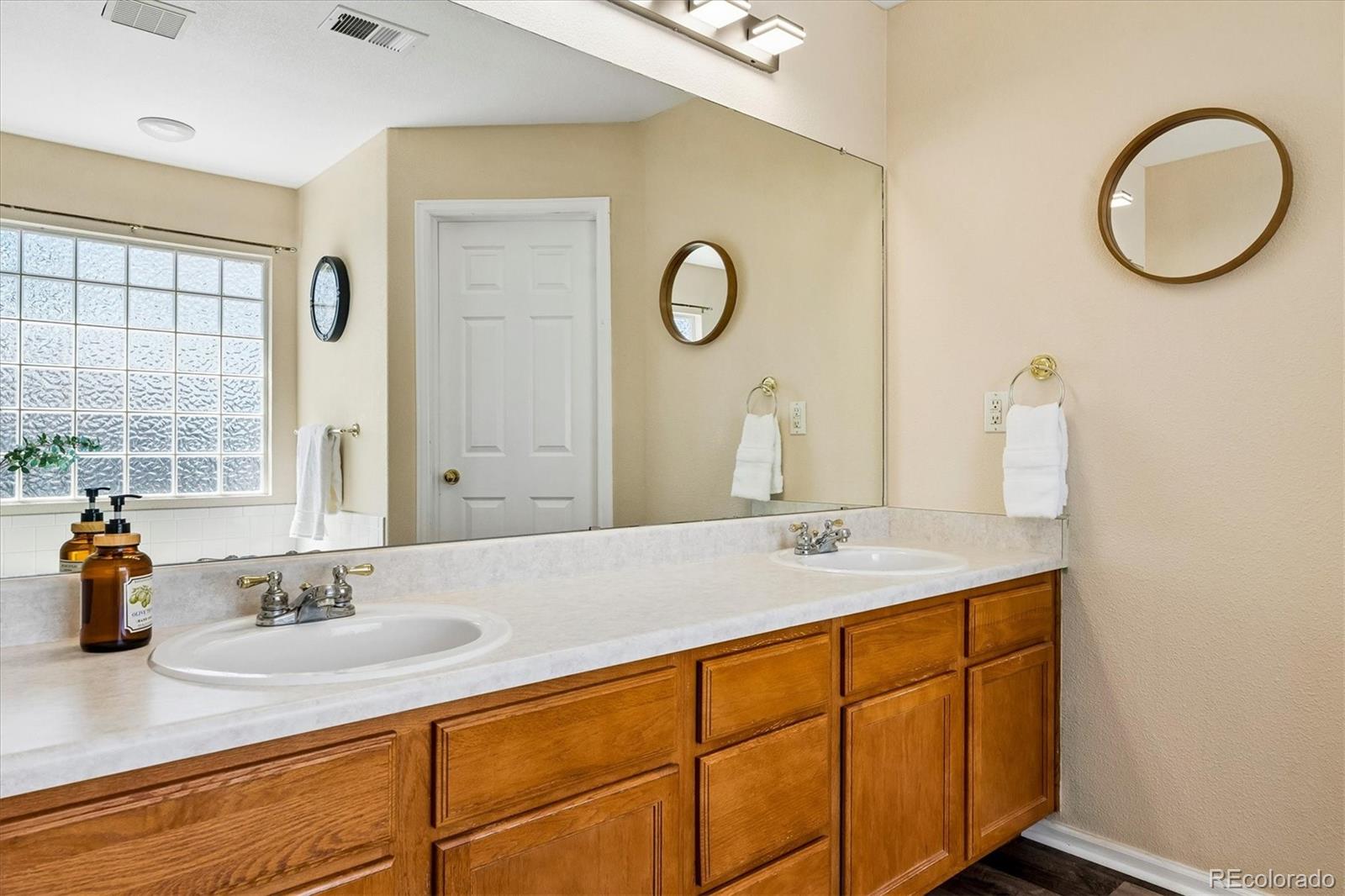 10534 Westcliff Place Highlands Ranch, CO 80130 - Photo 18 of 38 a bathroom with a granite countertop sink and a mirror
