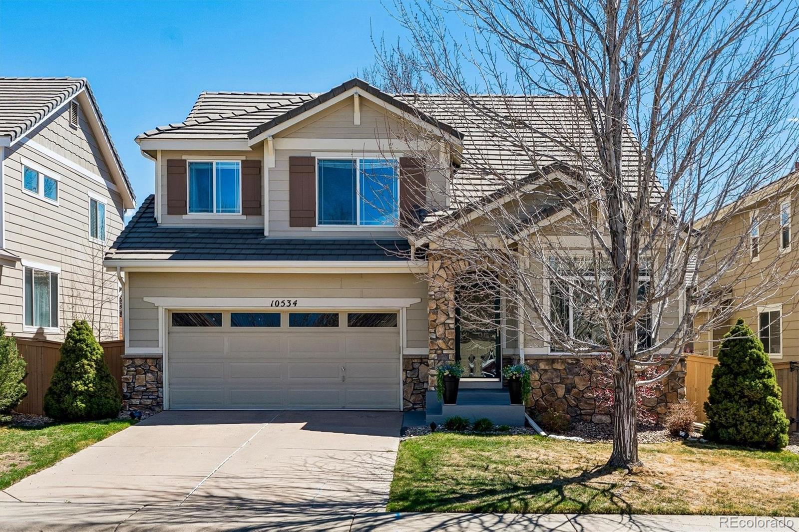10534 Westcliff Place Highlands Ranch, CO 80130 - Photo 2 of 38 a front view of a house with garden
