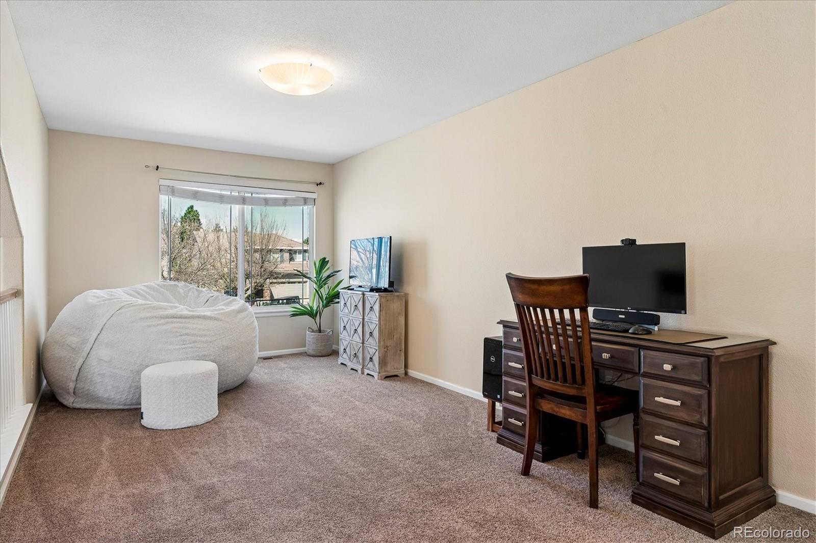 10534 Westcliff Place Highlands Ranch, CO 80130 - Photo 21 of 38 a bedroom with furniture and a window
