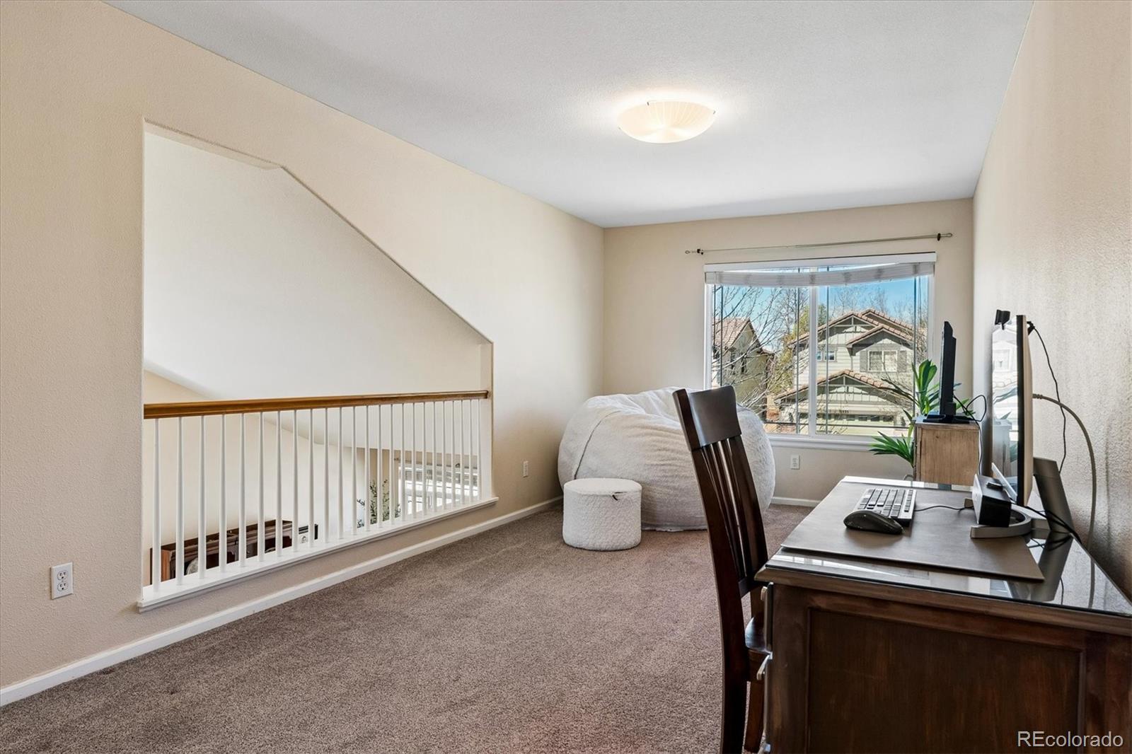 10534 Westcliff Place Highlands Ranch, CO 80130 - Photo 23 of 38 a view of a room with furniture and window