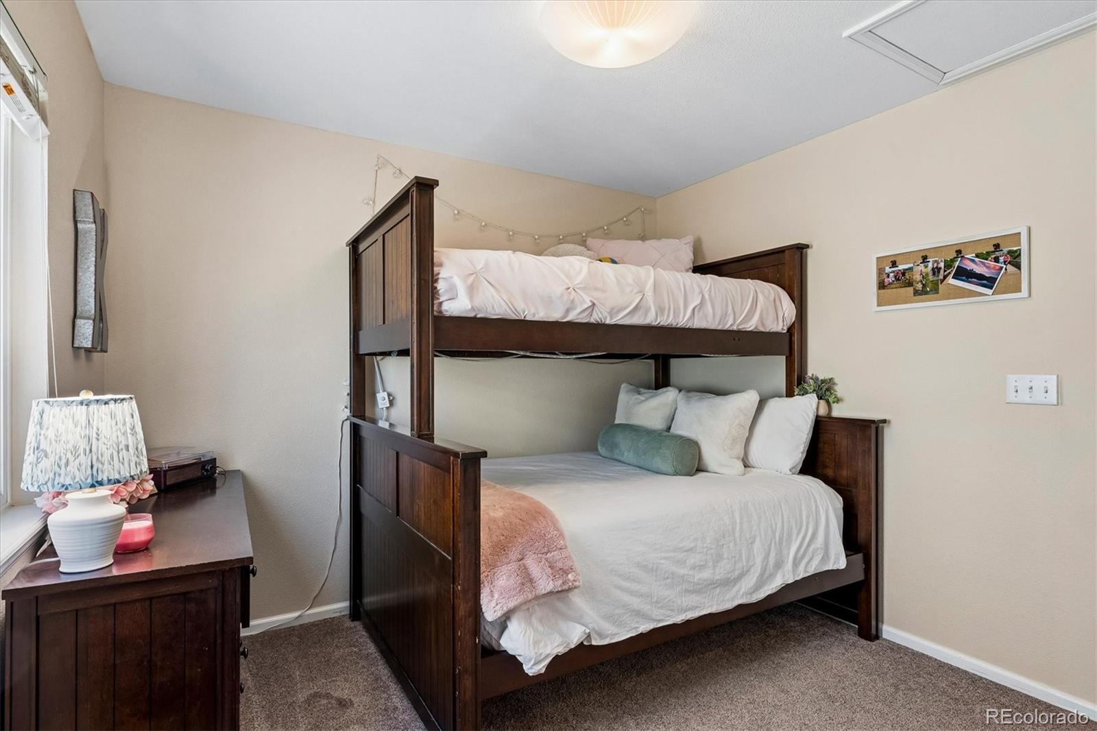 10534 Westcliff Place Highlands Ranch, CO 80130 - Photo 27 of 38 a bedroom with a bed and wooden floor