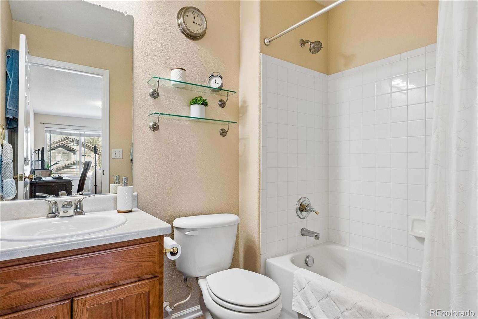 10534 Westcliff Place Highlands Ranch, CO 80130 - Photo 28 of 38 a bathroom with a sink a toilet and shower