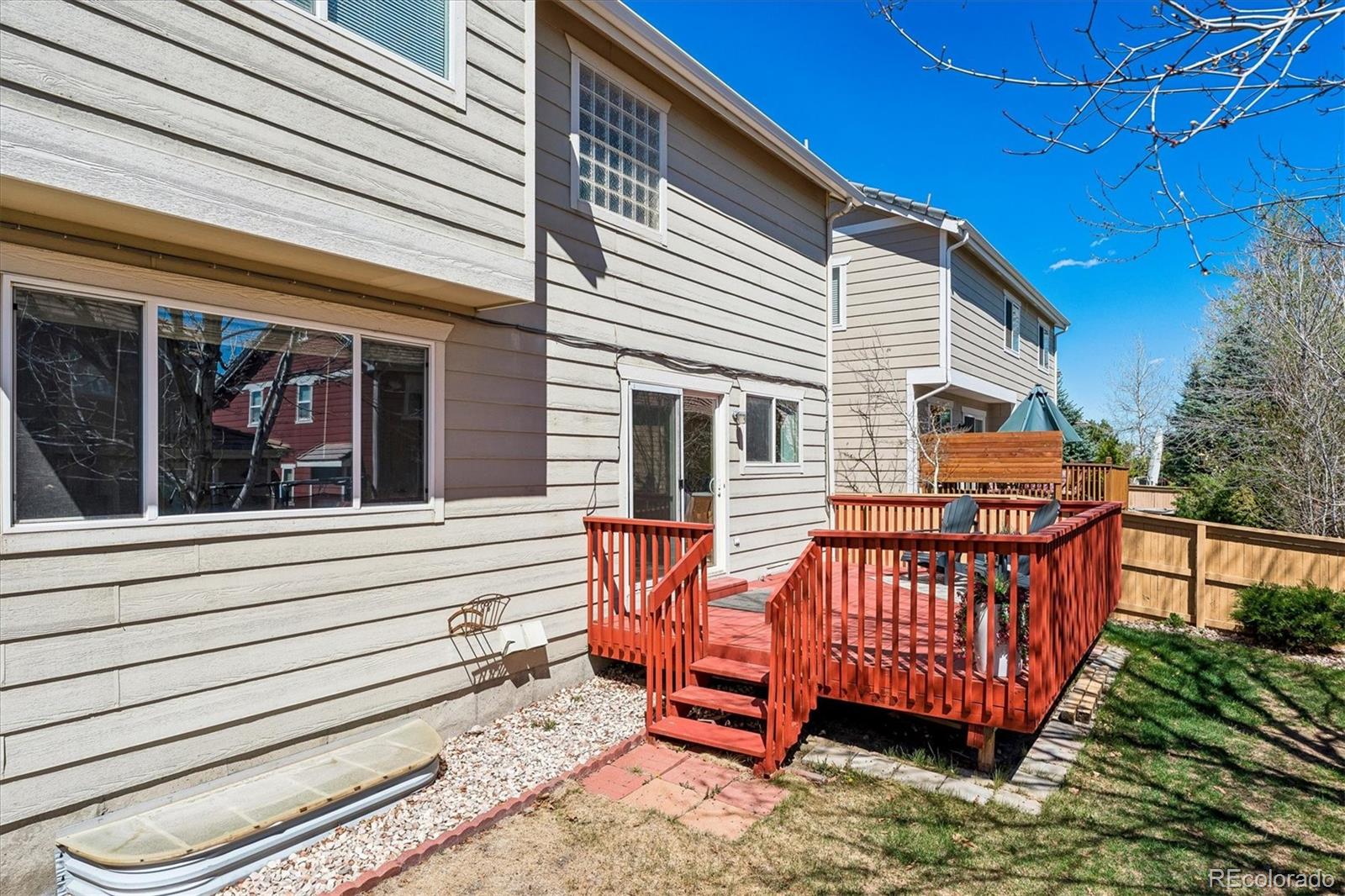 10534 Westcliff Place Highlands Ranch, CO 80130 - Photo 33 of 38 a backyard of a house with deck and outdoor seating