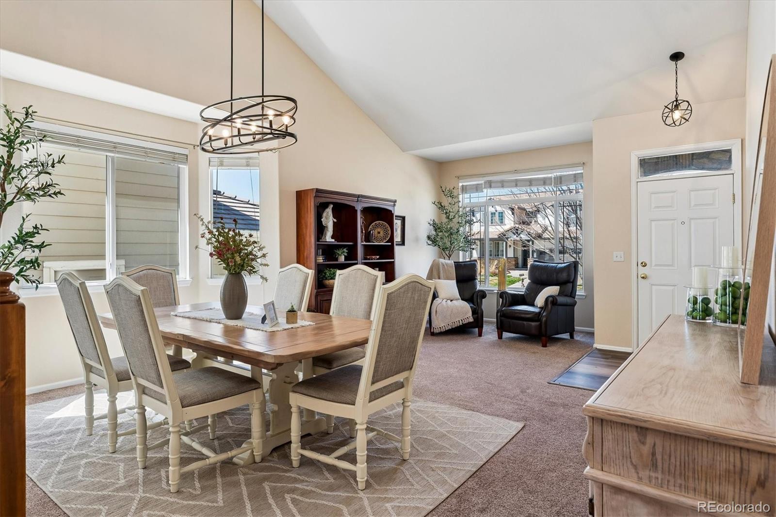 10534 Westcliff Place Highlands Ranch, CO 80130 - Photo 9 of 38 a view of a dining room with furniture a chandelier and window