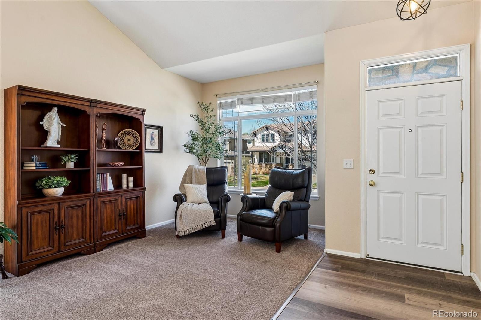 10534 Westcliff Place Highlands Ranch, CO 80130 - Photo 10 of 38 a living room with furniture and wooden floor