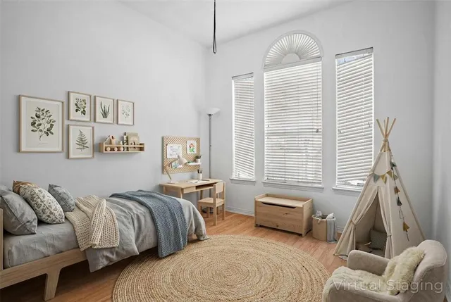 a bedroom with two beds and a large window
