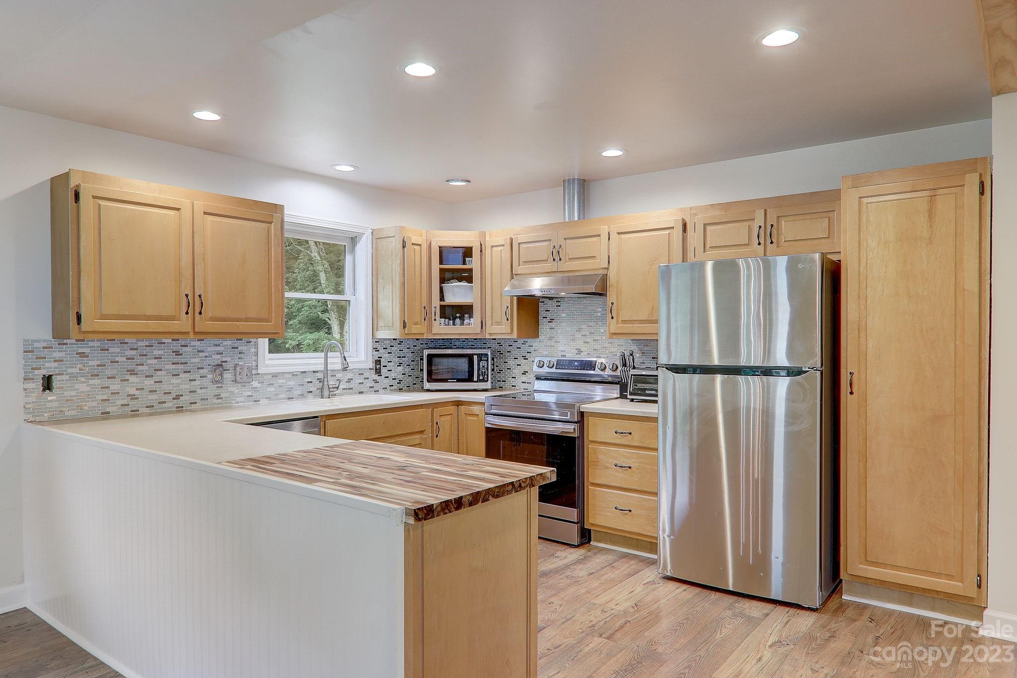 4155 Turnpike Road Horse Shoe, NC 28742 - Photo 13 of 41 a kitchen with stainless steel appliances granite countertop a refrigerator and a sink