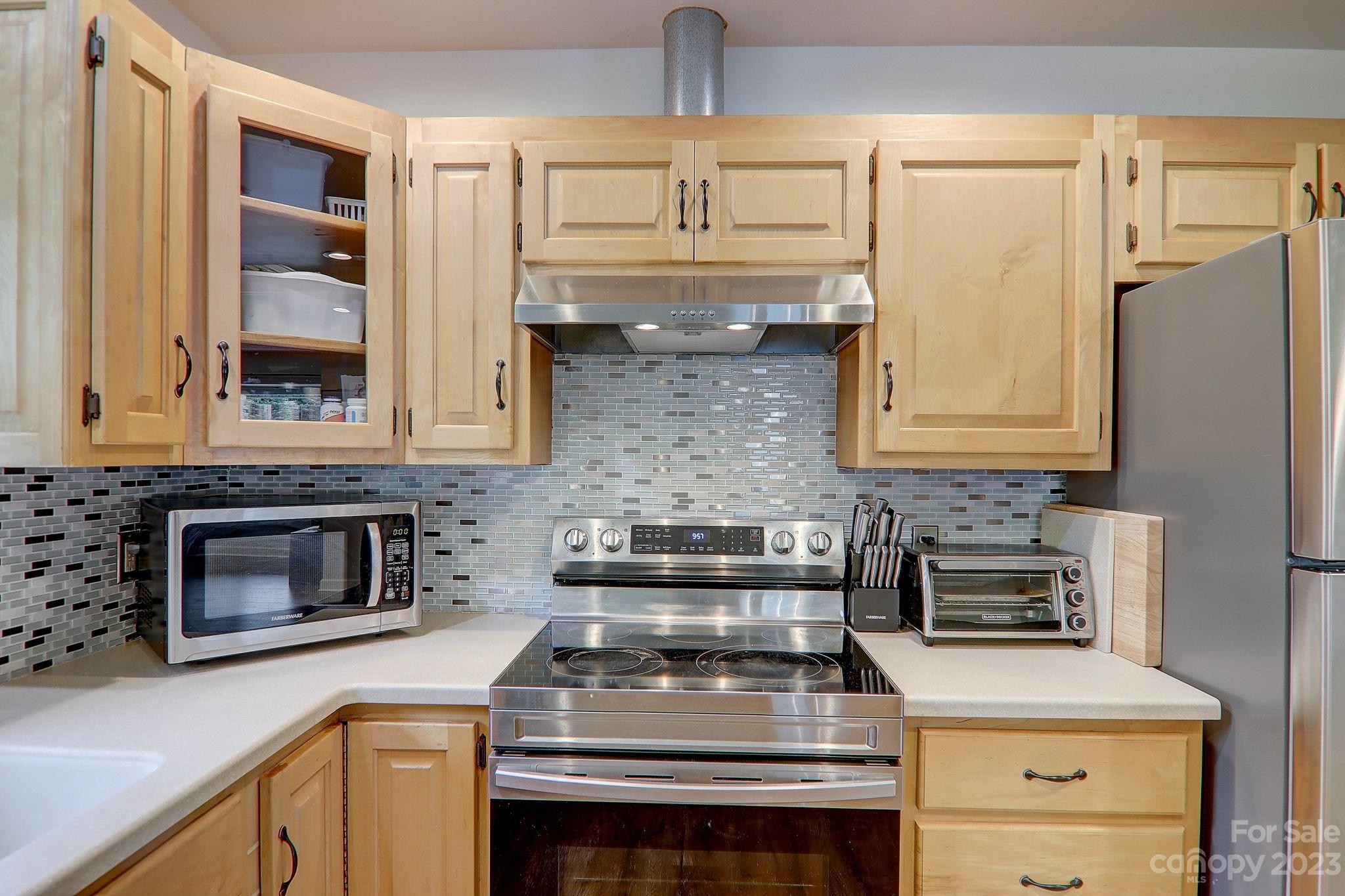 4155 Turnpike Road Horse Shoe, NC 28742 - Photo 16 of 41 a kitchen with granite countertop a stove and a microwave