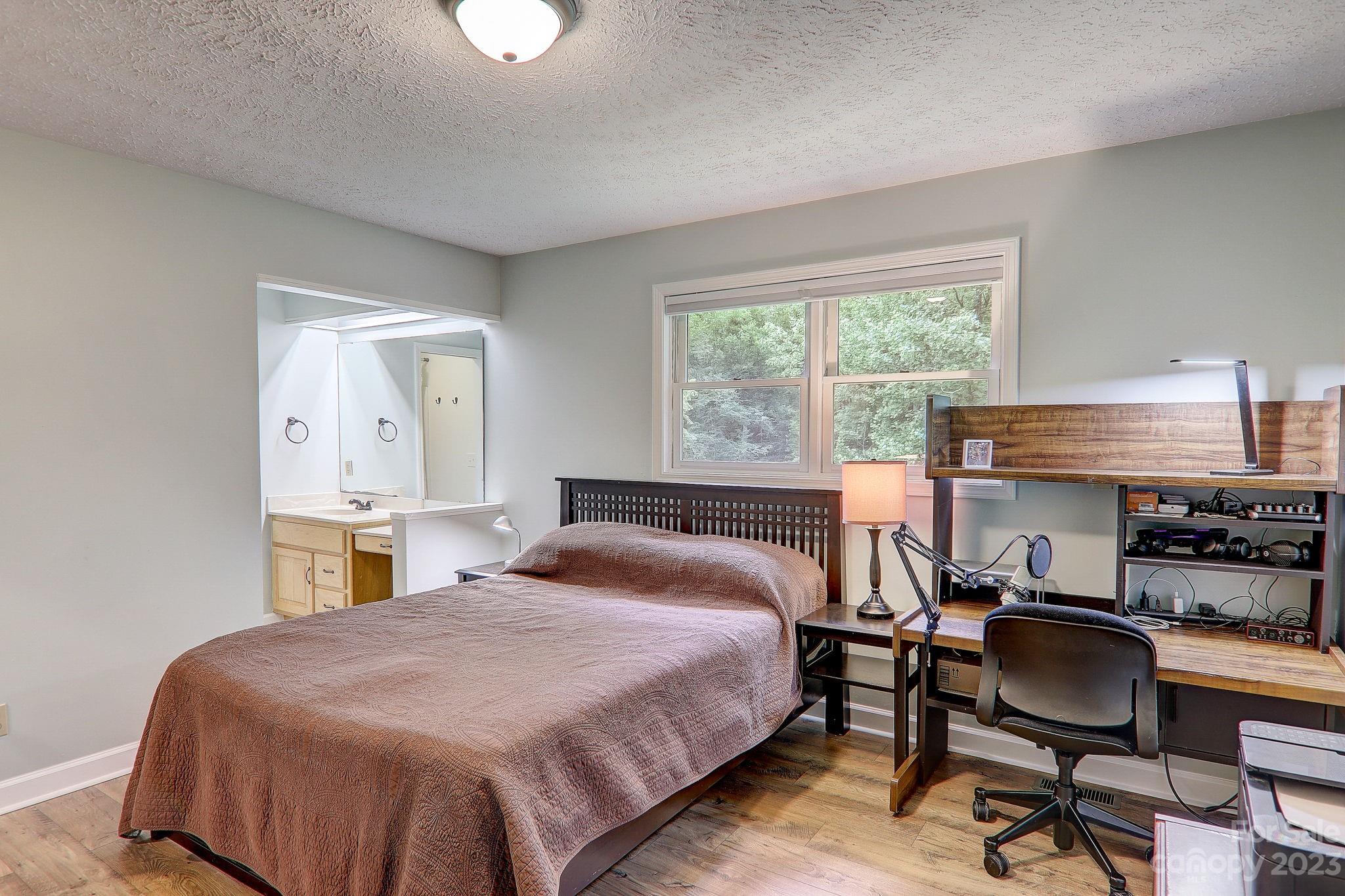 4155 Turnpike Road Horse Shoe, NC 28742 - Photo 18 of 41 a bedroom with a bed and a desk