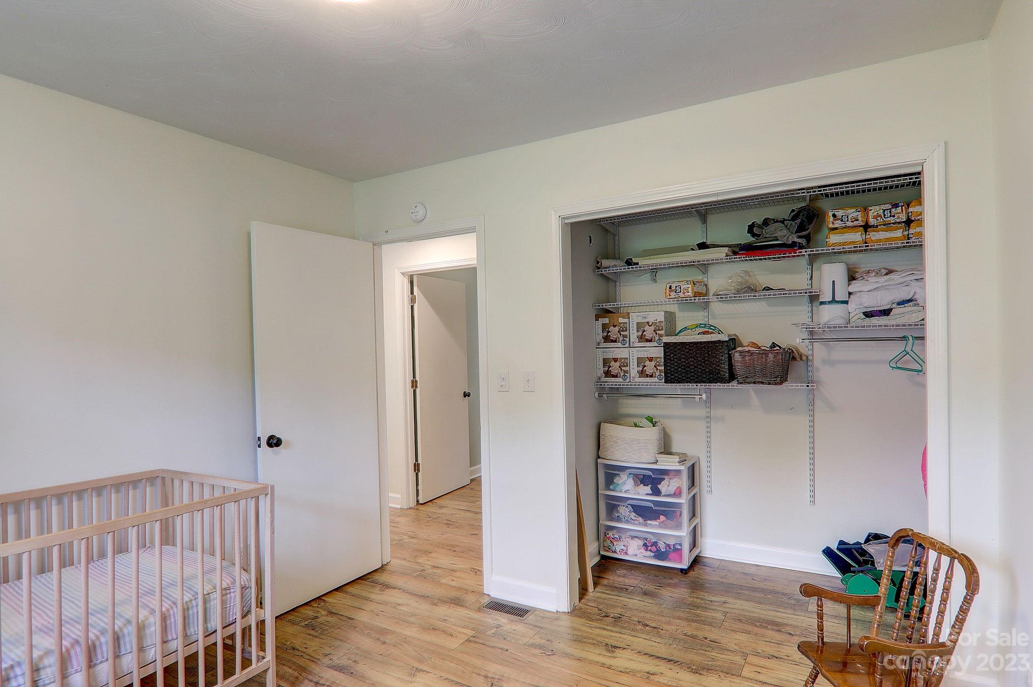 4155 Turnpike Road Horse Shoe, NC 28742 - Photo 23 of 41 a view of a hallway to room with wooden floor and furniture