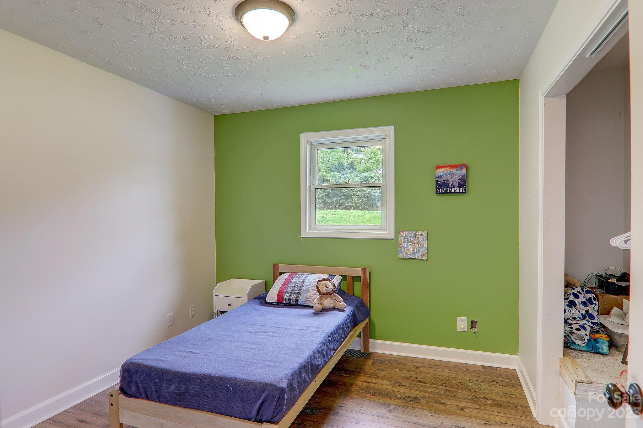 4155 Turnpike Road Horse Shoe, NC 28742 - Photo 24 of 41 a bedroom with a bed and a window