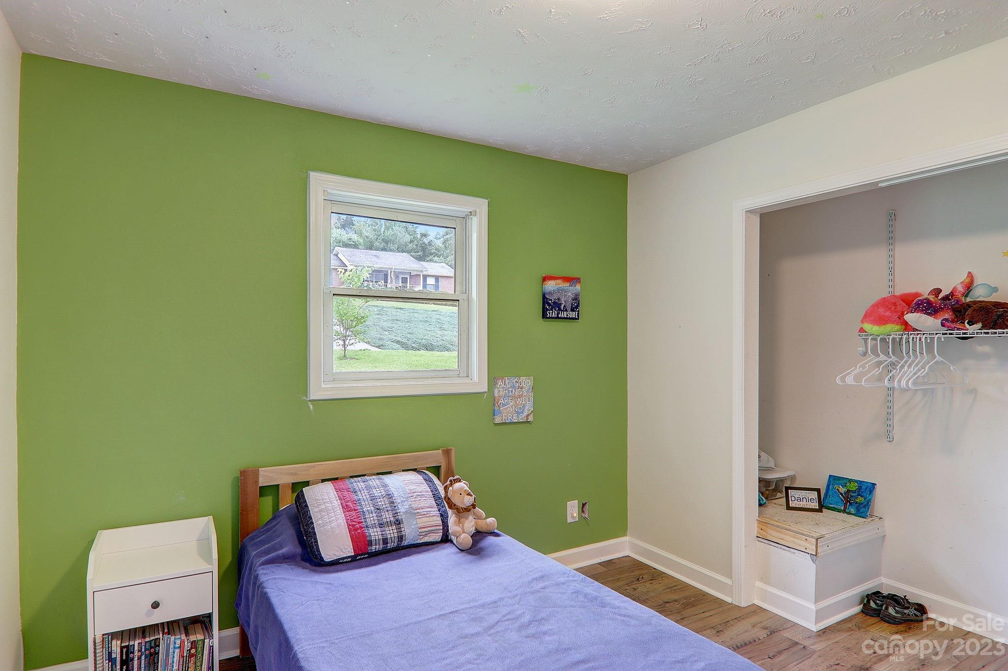 4155 Turnpike Road Horse Shoe, NC 28742 - Photo 25 of 41 a bedroom with a bed and wooden floor