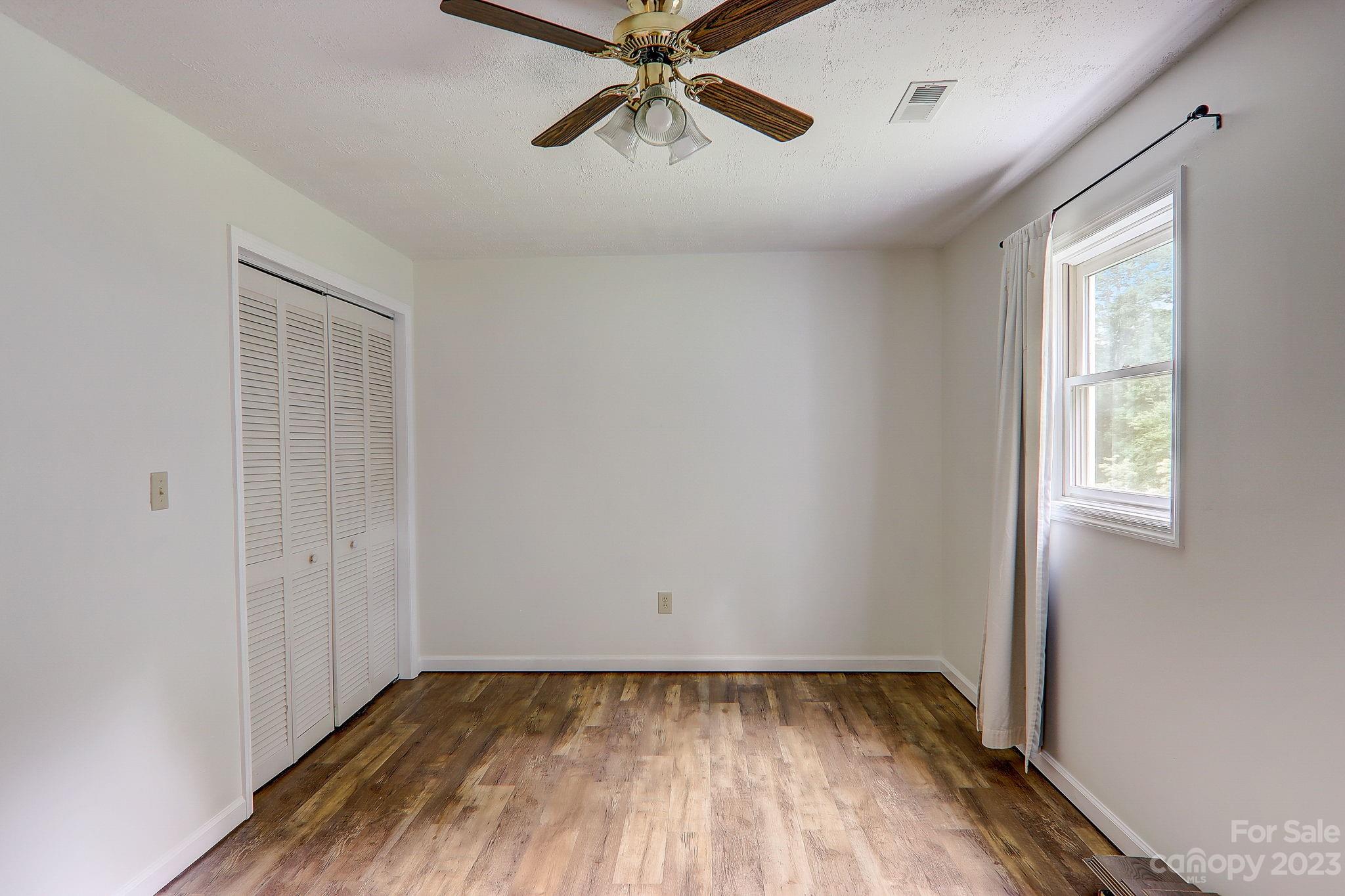 4155 Turnpike Road Horse Shoe, NC 28742 - Photo 29 of 41 a view of an empty room with wooden floor and a window