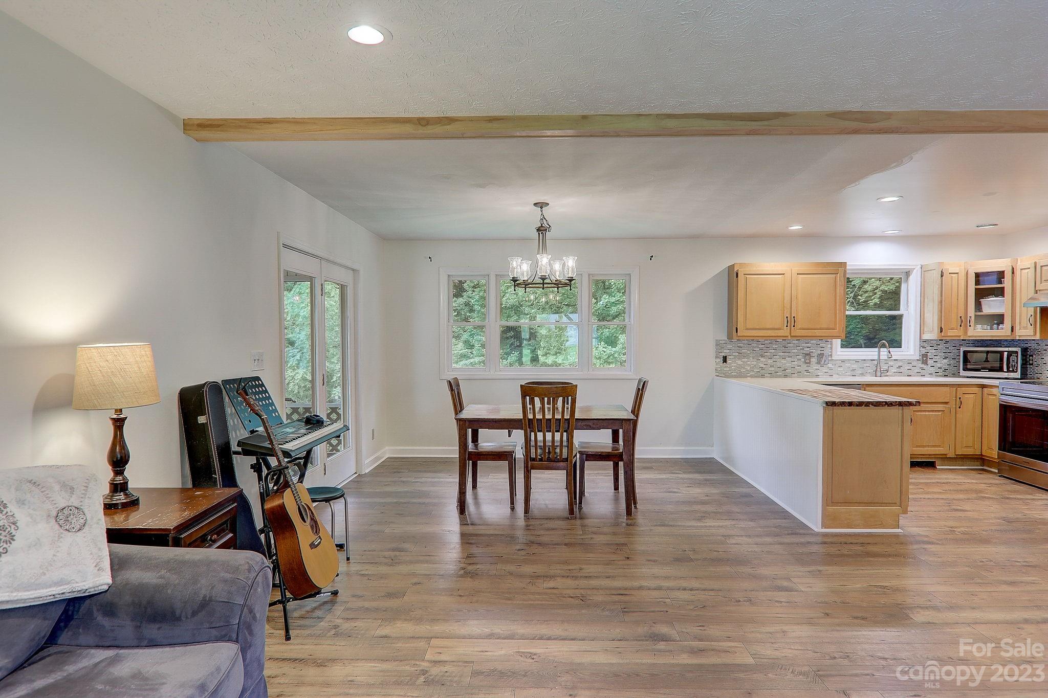 4155 Turnpike Road Horse Shoe, NC 28742 - Photo 9 of 41 a view of a dining room with furniture window and wooden floor