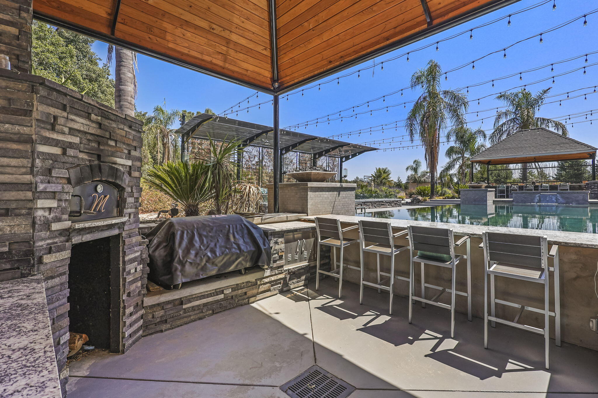 19580 Mockingbird Lane Redding, CA 96002 - Photo 30 of 72 a view of a patio with a table and chairs under an umbrella