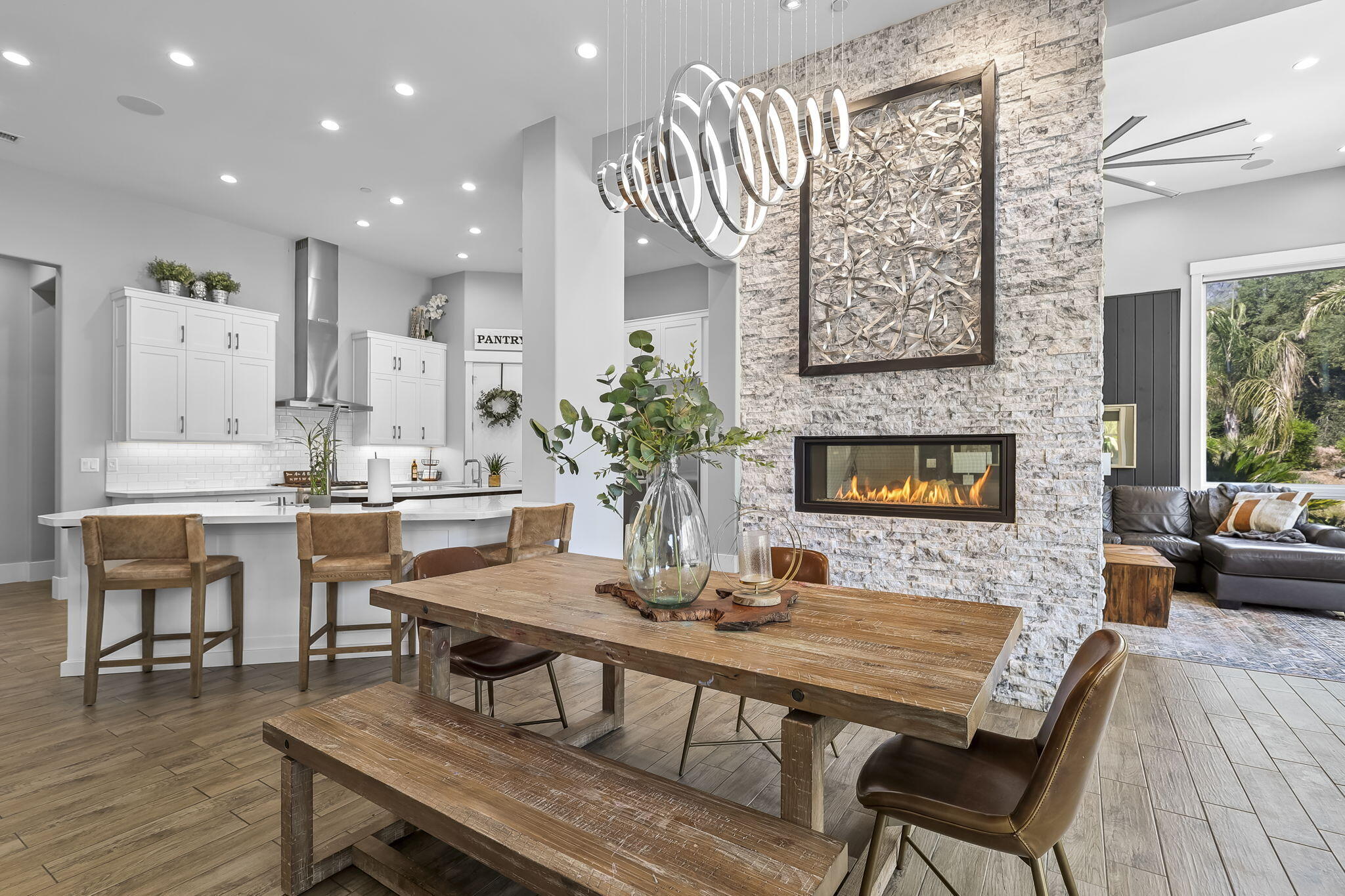 19580 Mockingbird Lane Redding, CA 96002 - Photo 44 of 72 a dining room with furniture a large window and a fireplace