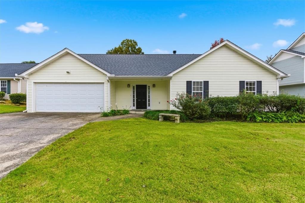 a front view of house with yard and green space