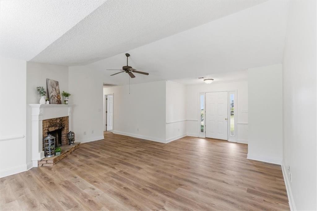 9 Redfern Trail Northeast Rome, GA 30165 - Photo 4 of 19 a view of empty room with wooden floor and fireplace