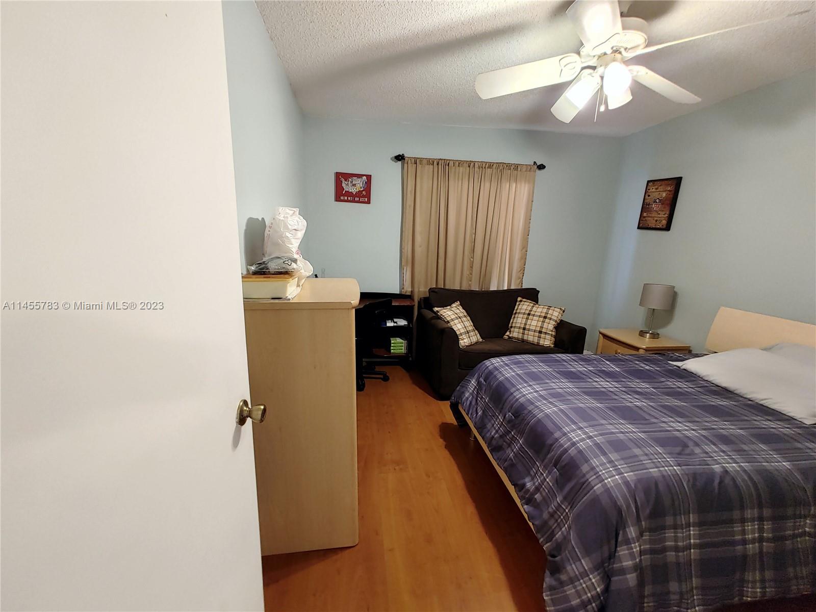 894 Northwest 134th Place, Unit 894 Miami, FL 33182 - Photo 22 of 46 a bedroom with bed and window