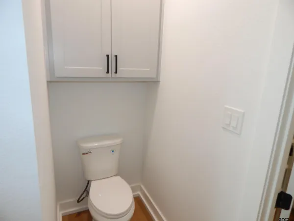 a white toilet sitting next to a shower curtain
