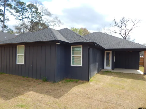 a view of a house with wooden fence