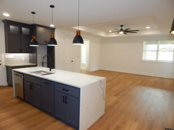 a bathroom with a sink a vanity and a large mirror