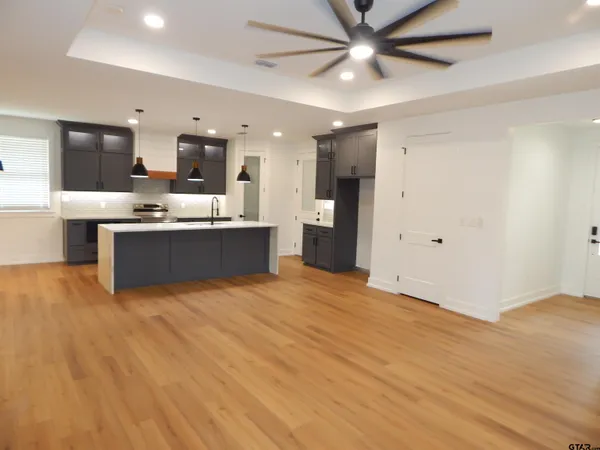 a kitchen with stainless steel appliances granite countertop a sink and cabinets