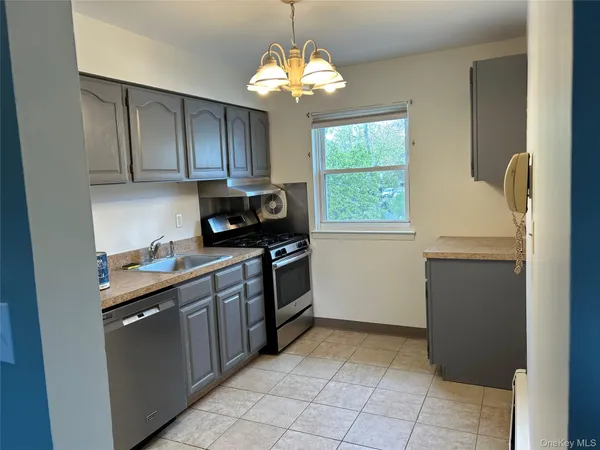 a kitchen with a stove window and cabinets