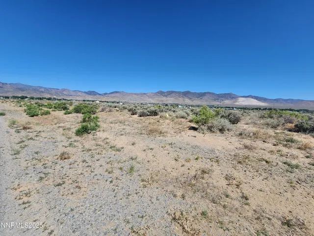 a view of ocean beach and mountain