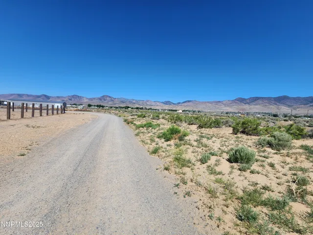 a view of a large mountain with mountains in the background