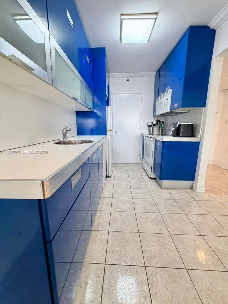 100 Lincoln Road, Unit 1423 Miami Beach, FL 33139 - Photo 7 of 17 a kitchen with a cabinets and counter space